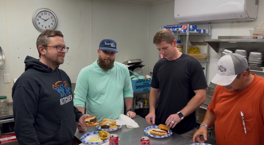 Men from The Ridge Recovery Housing at Waller sharing a meal together in the community kitchen