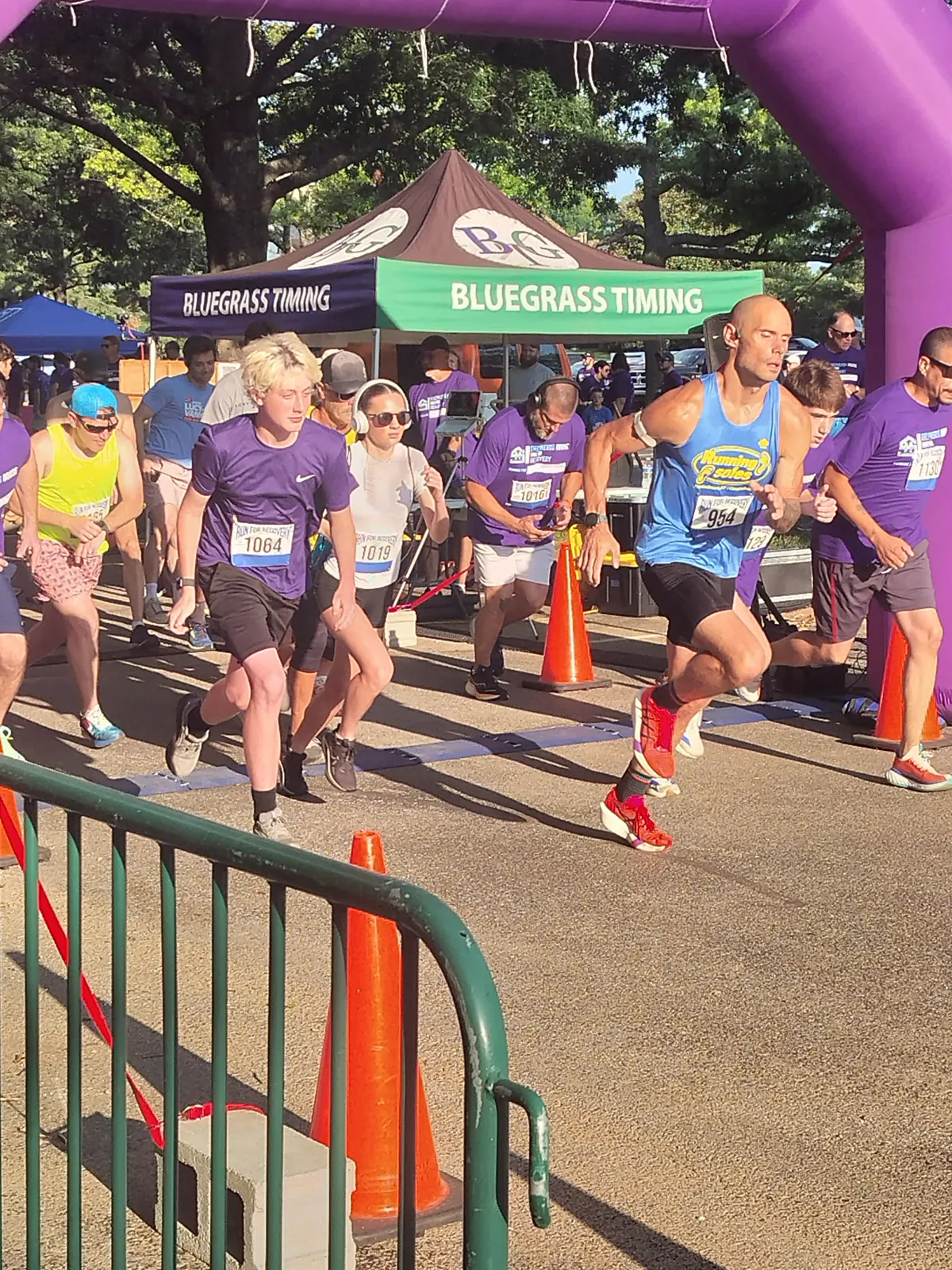 Runners and walkers in purple Run for Recovery shirts on the course