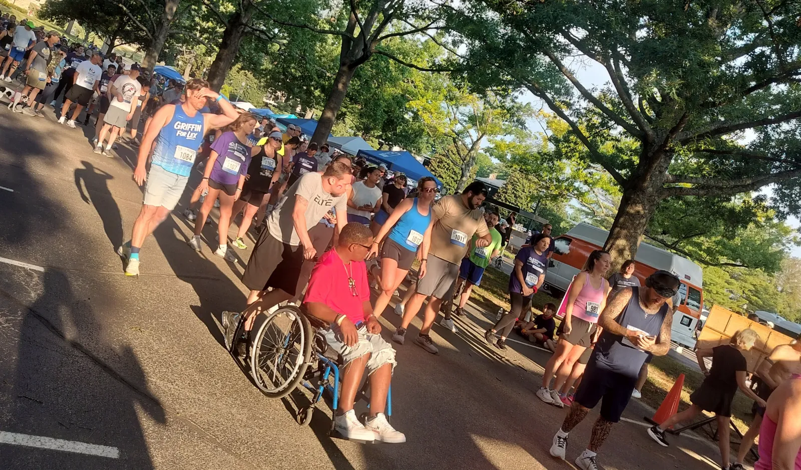 Run for Recovery participants posing with the event marquee sign