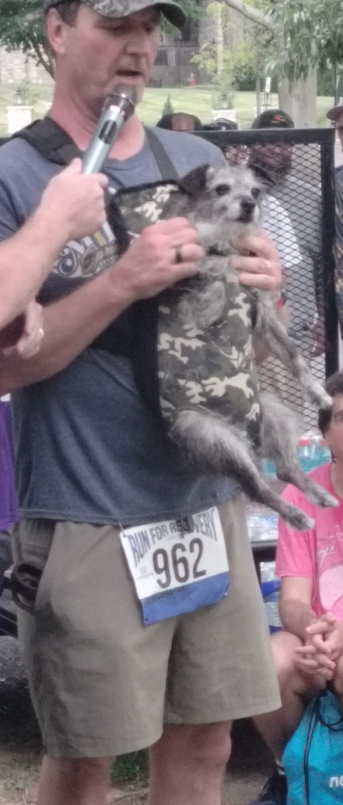 A runner celebrating with a finisher medal at the Run for Recovery
